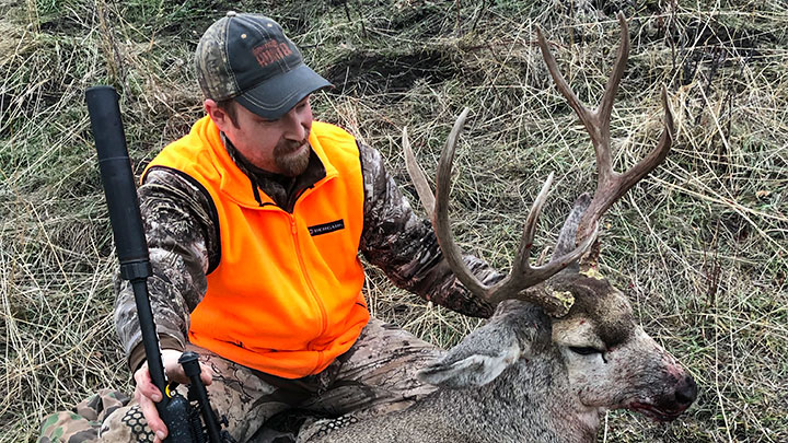 Hunter with mule deer buck