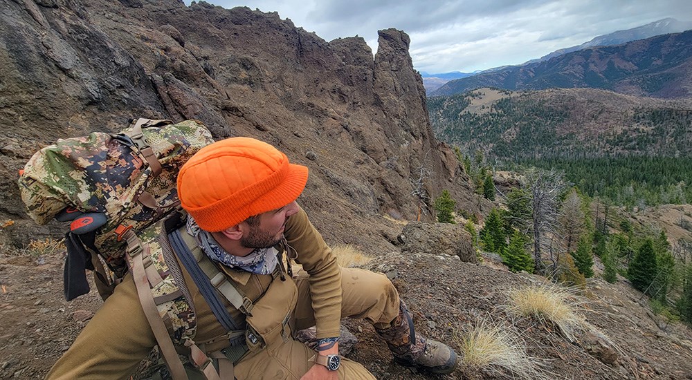 Hunters kneeling on Wyoming mountain top.