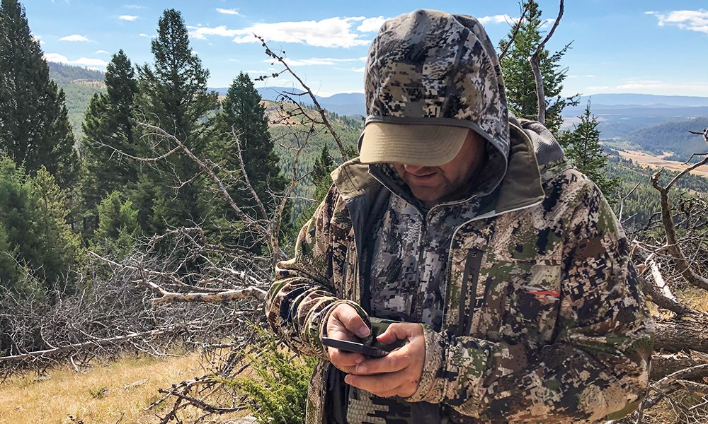 Hunter Using Cell Phone Hunting App for GPS
