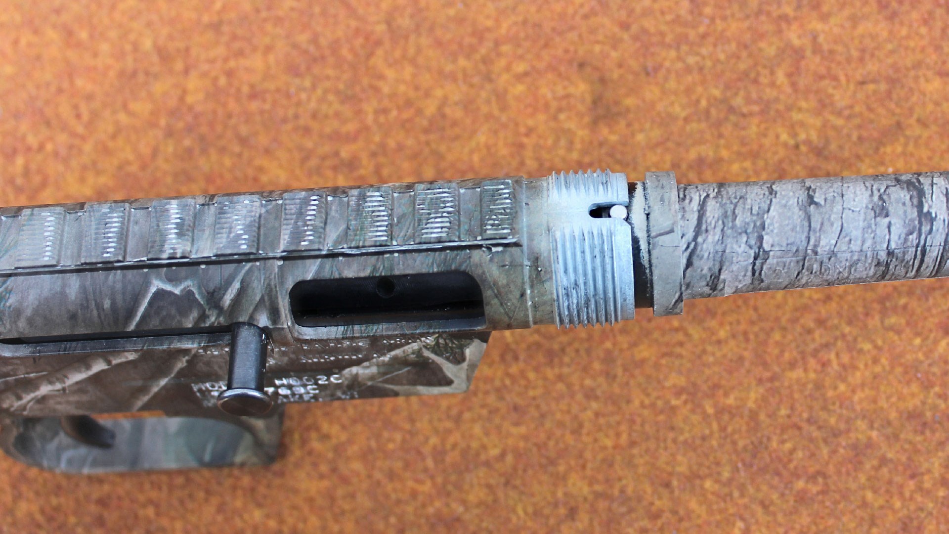 A pin atop the barrel chamber, AR style