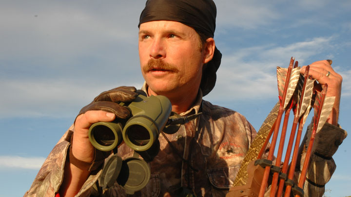 Hunter with a primitive bow glasses for javelina.