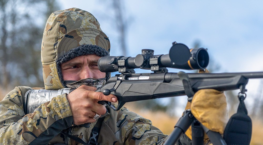 Hunter looking though Leupold rifle scope on Benelli bolt action rifle
