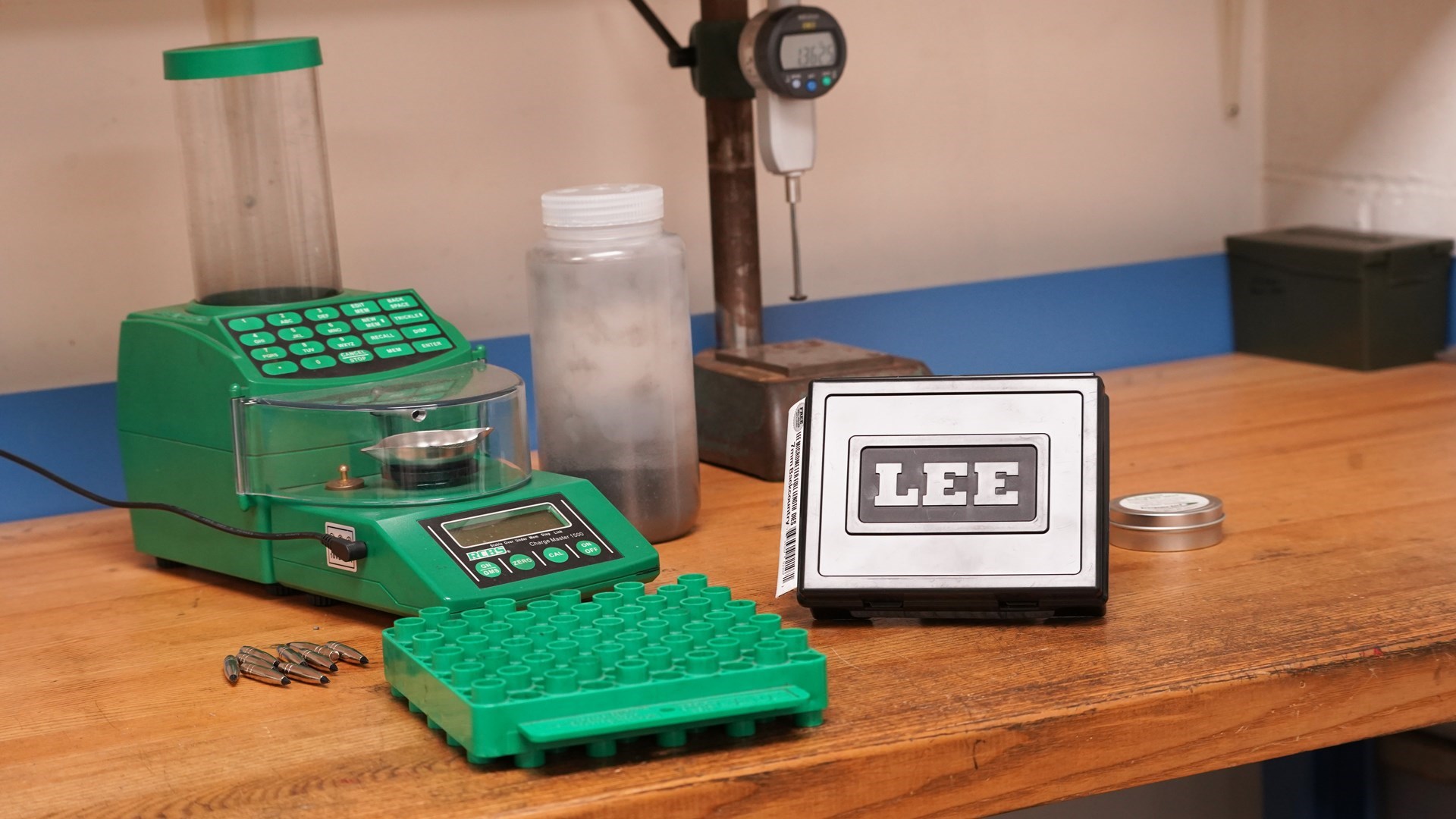 Lee Precision reloading die box shown with RCBS reloading gear tools on wood bench table