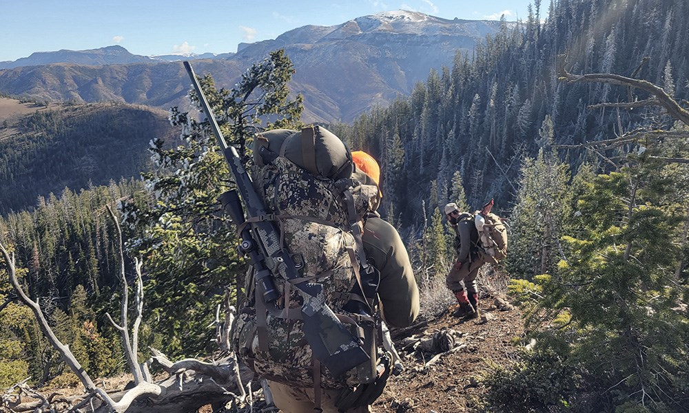 Hunters walking on Wyoming mountainside.