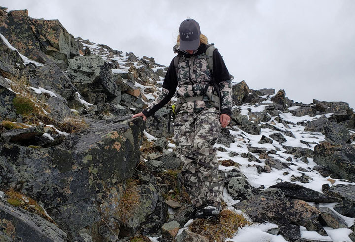 Hunter wearing Azye camo in a snowy patch of rocks