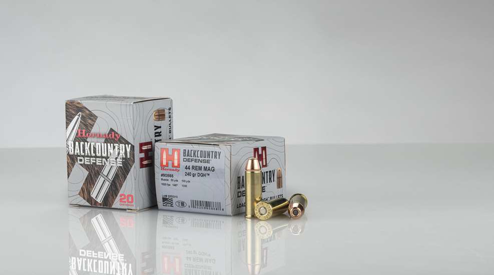 Hornady Backcountry Defense ammunition boxes bullets arranged on white gray table with clear shadow below packaging