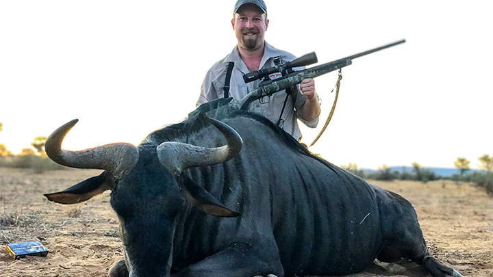 Hunter with blue wildebeest