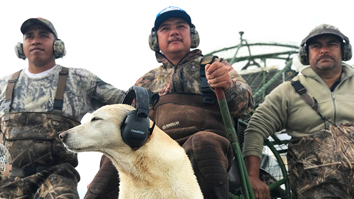 Hunting guides and dog on boat