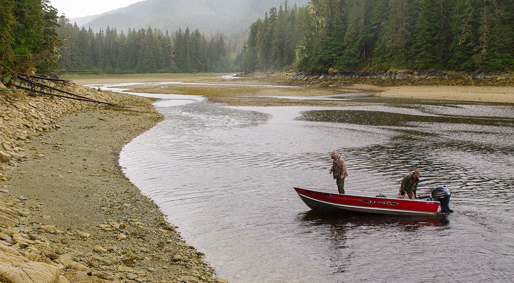 Hunters in boat gliding toward shore