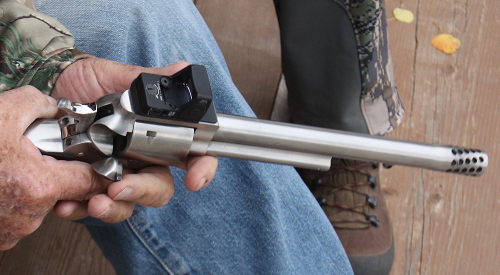 Male hands holding revolver on handgun elk hunt.