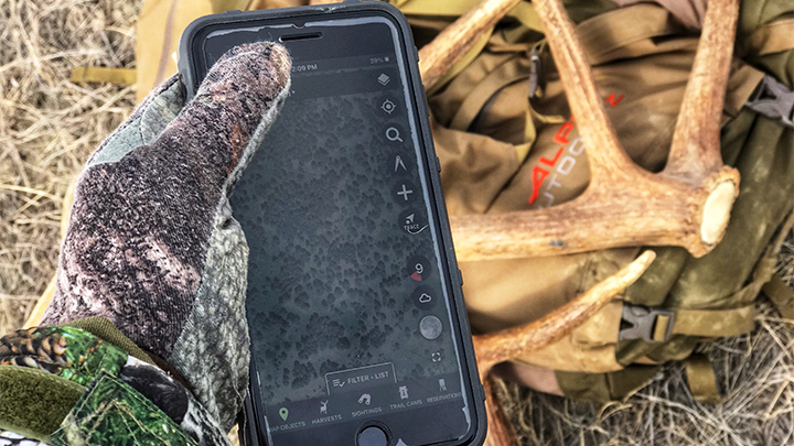 Man using hunting app for navigation and notes