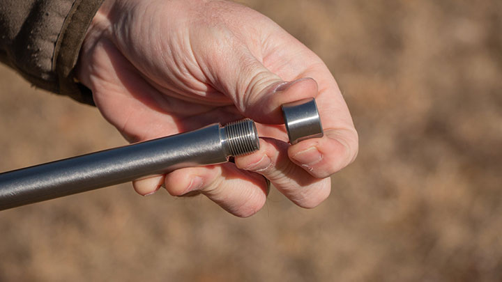 Author threading a protective cap onto the muzzle.