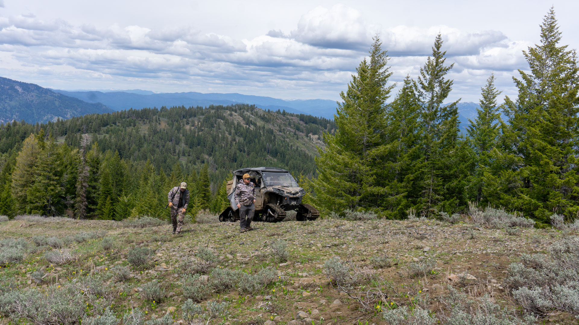 Hunters near tracked vehicle
