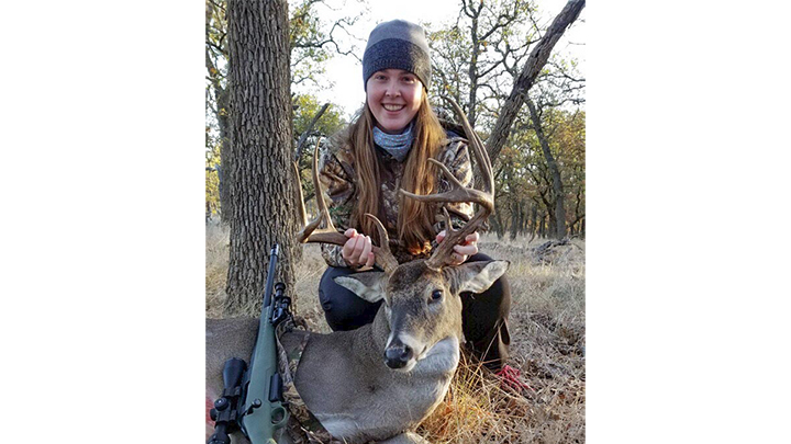 Female hunter with first whitetail buck in Texas