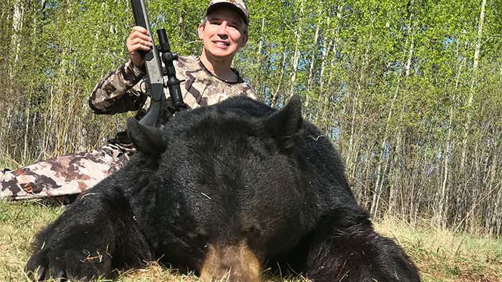 Hunter with Black bear in Alberta