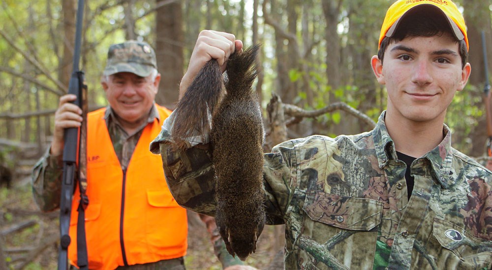 Youth Hunter Holding Squirrel