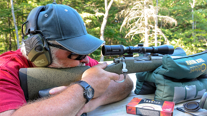 Man Shooting Rifle Off Bench