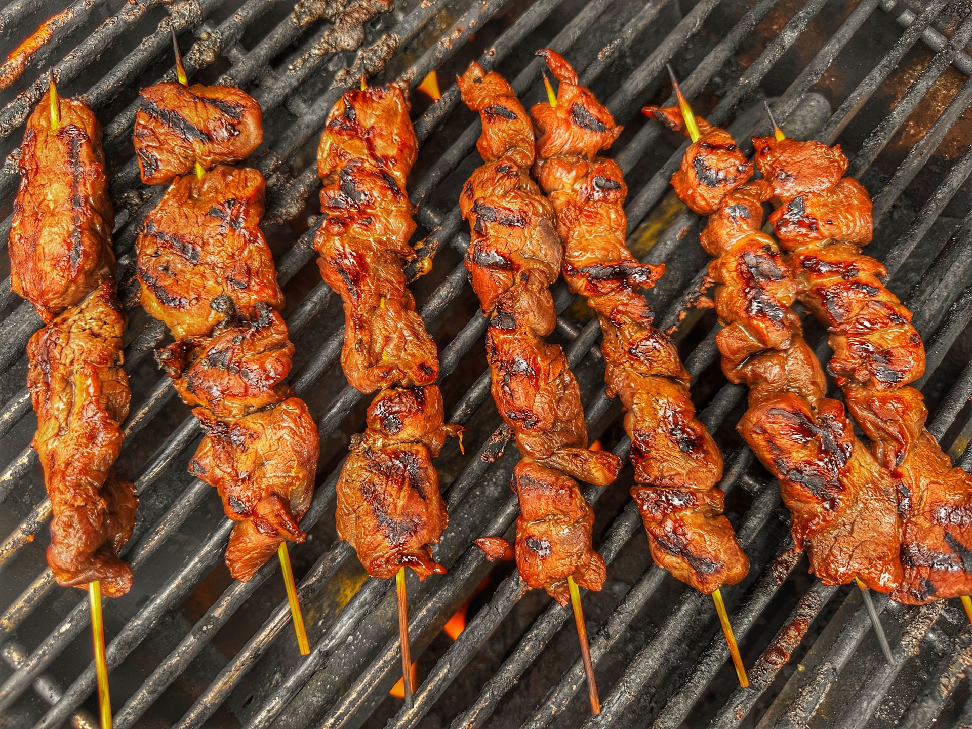 Skewers cooking on grill