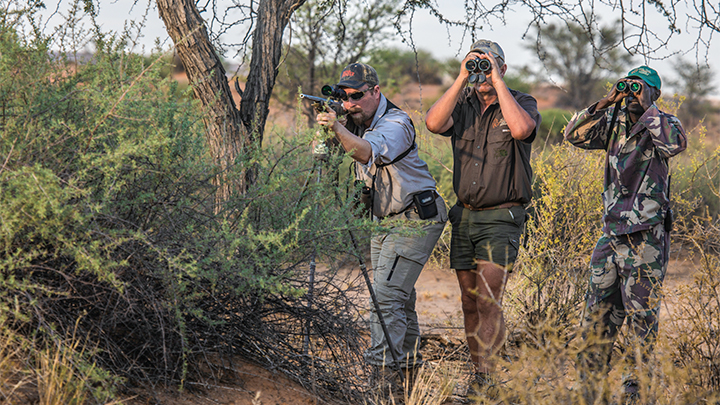 Hunter with PH in Africa shooting off sticks