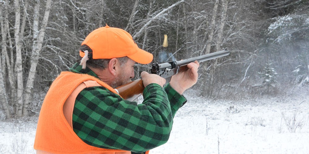 Man Shooting Lever Action Rifle