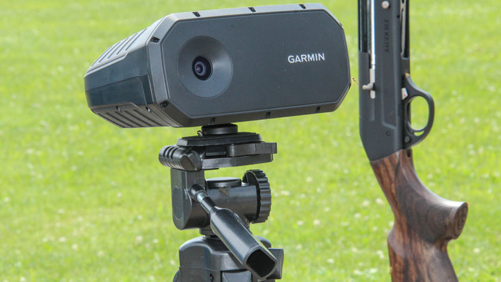 Garmin Xero S1 on Tripod next to shotgun. Grassy green background.