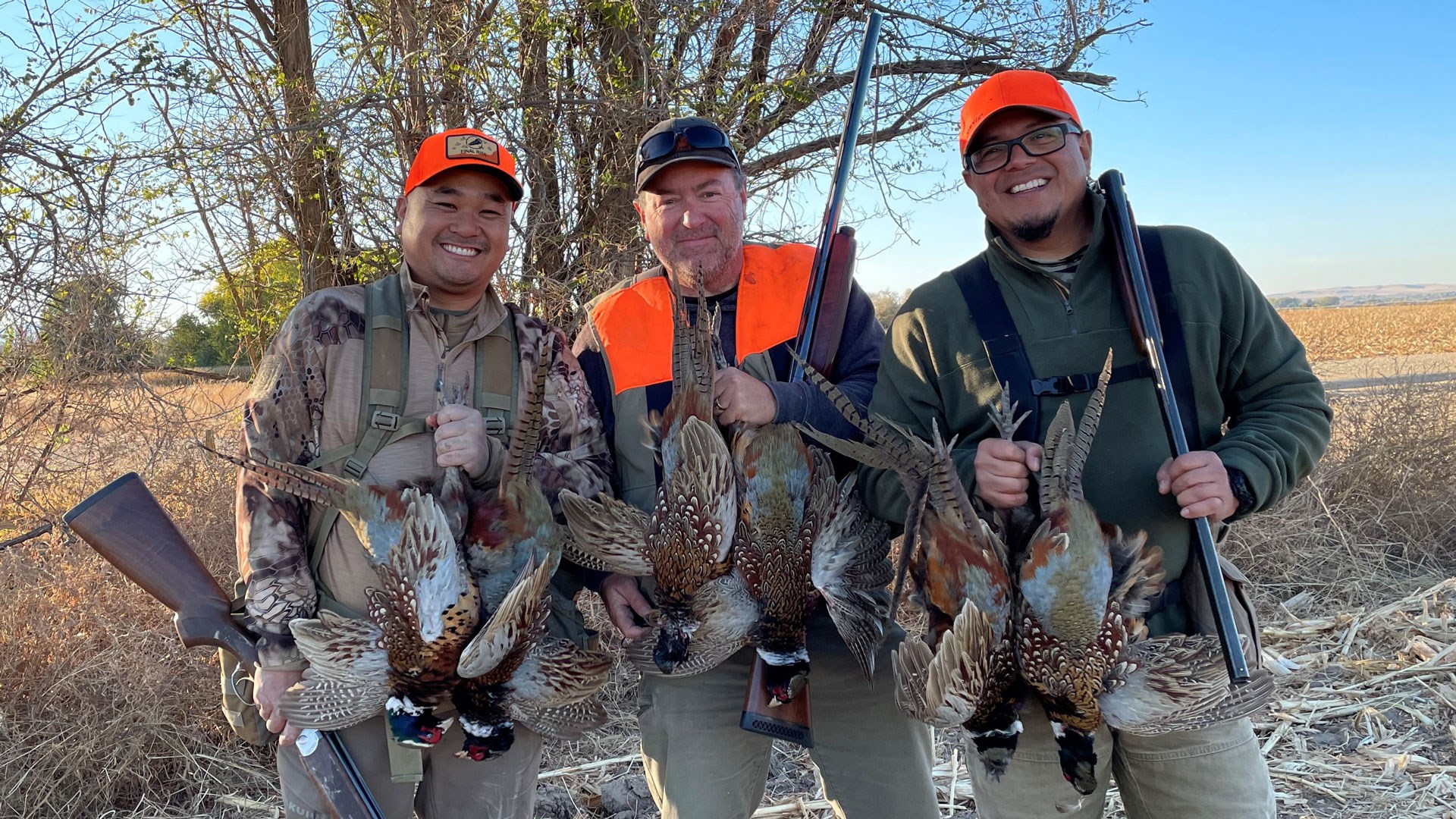 Hunters with pheasants