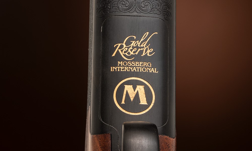 Mossberg International Gold Reserve Black label logo on underside of shotgun action.