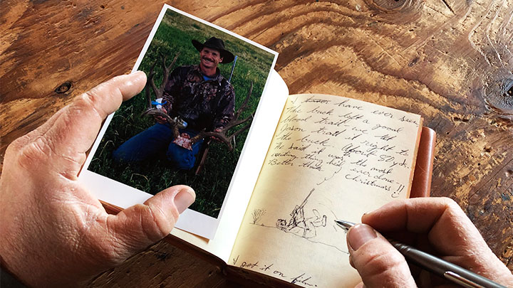 Man Illustrating in Journal While Holding Photo