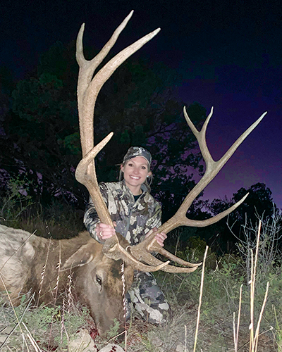 Female hunter with bull elk taken at 350 yards
