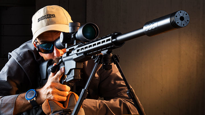 Man shooting rifle with suppressor