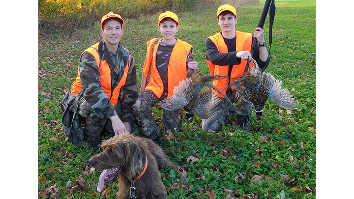 Father and sons hunting pheasants