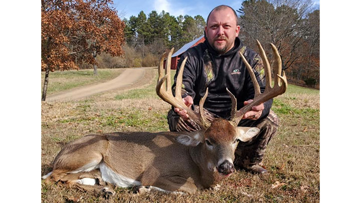 Hunter with Large Whitetail Buck in Texas County, Missouri.