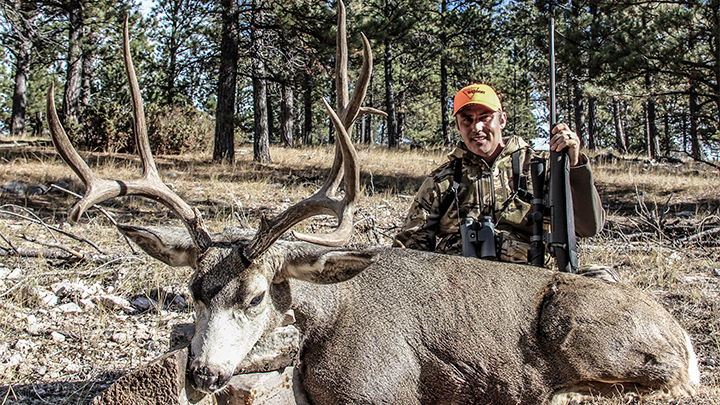 Hunter with Mule Deer Buck