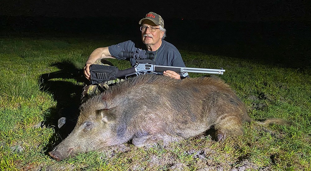Male hunter with 200 pound boar taken in Texas.