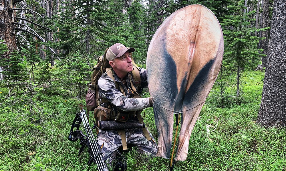 Male hunter setting up elk rump decoy.