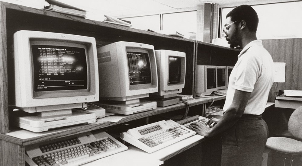 Employee on Computer at Remington Cartridge Corporation