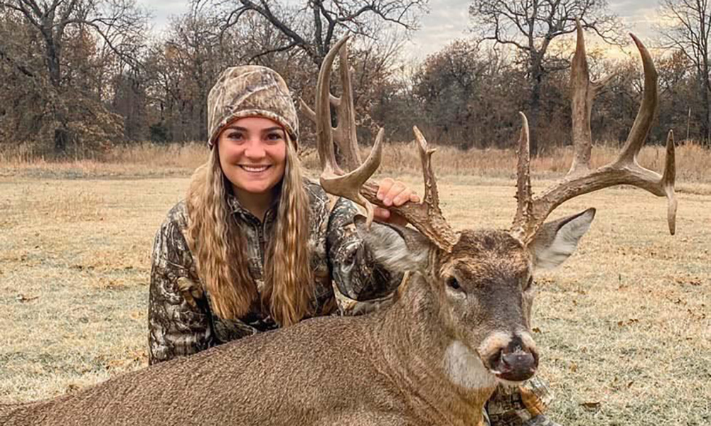 Female hunter with whitetail buck she killed in Garmin County, Oklahoma.