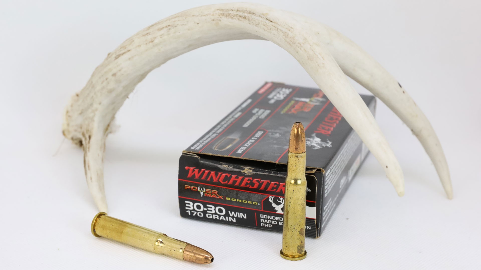 30-30 Winchester with antlers on white
