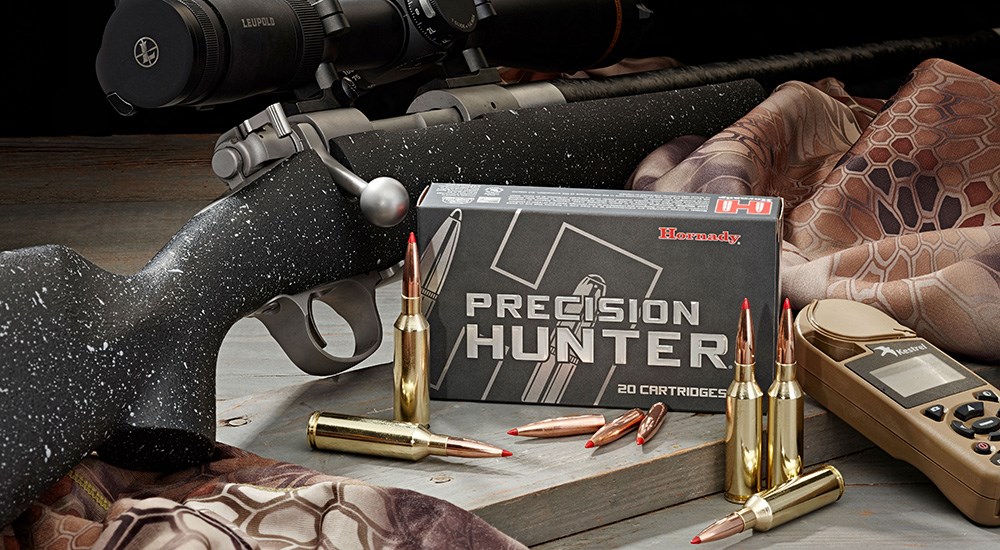 Browning bolt-action rifle laying next to Hornady Precision Hunter 6.5 PRC ammunition.