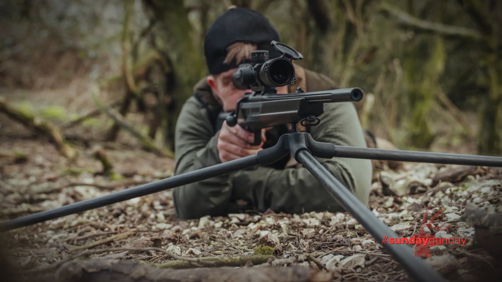 Spartan Precision Springbok Tripod with rifle and shooter outdoors on ground low profile tripod spring head