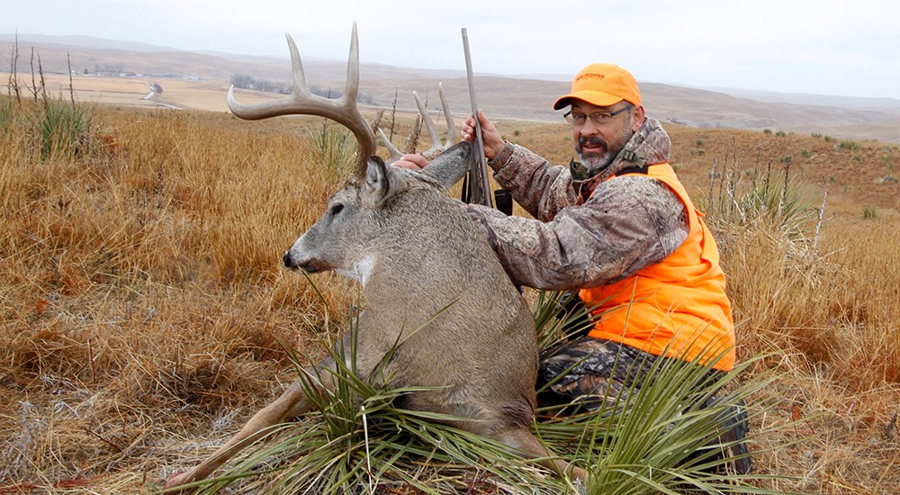 Hunter with whitetail deer.