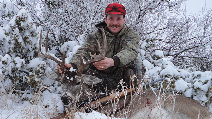 Hunter with Whitetail Buck