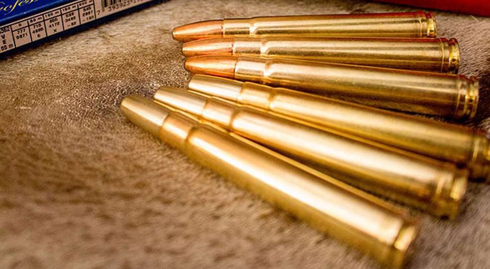 .375 Holland and Holland Magnum rifle cartridges on deer skin rug.