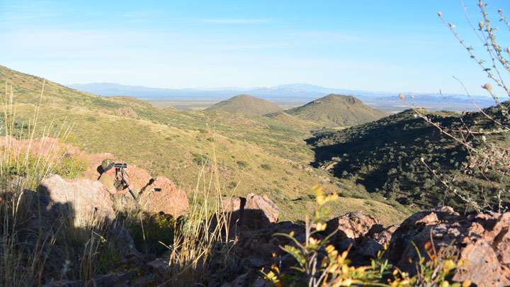 Hunter glassing a Western valley