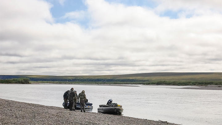 Hunters loading into large motorized raft