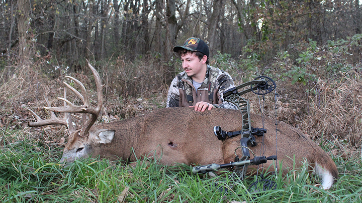 Iowa bowhunter with whitetail buck