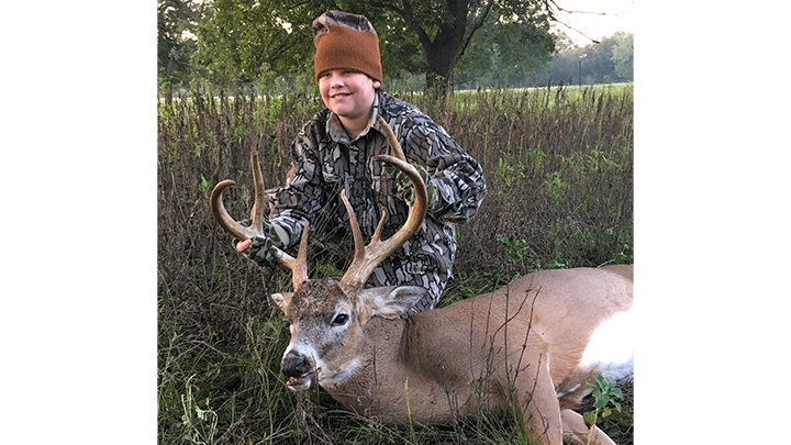 Young hunter with first buck in Texas