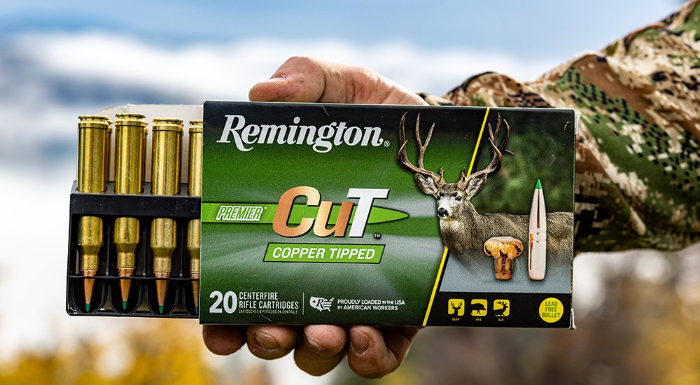 Remington Premier CuT ammunition in box held by male wearing camouflage.
