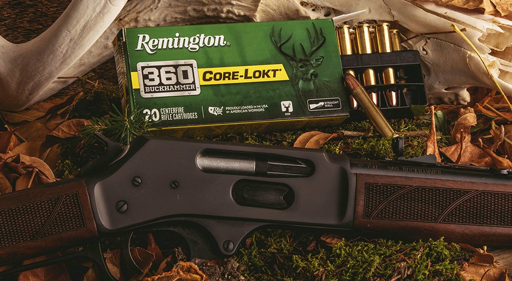 Remington 360 Buckhammer Core-Lokt ammunition with lever action rifle on grass.