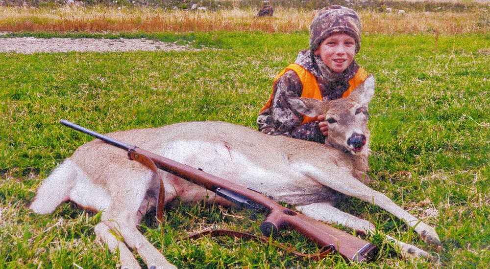 Young hunter with first whitetail doe